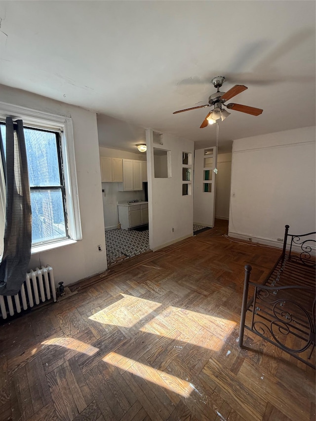 1177 Anderson Ave Unit 2B, Bronx, NY 10452 - unfurnished living room with radiator heating unit and a ceiling fan