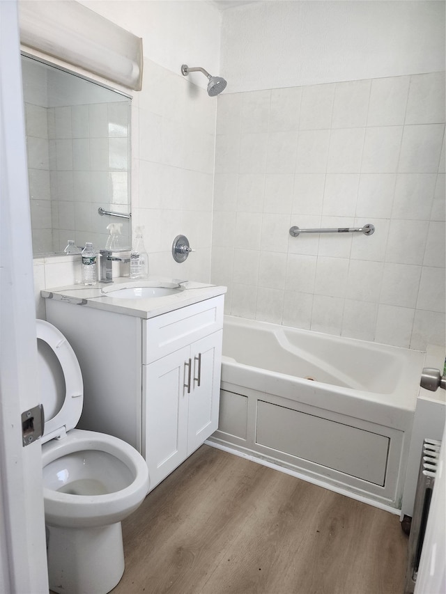 88-38 201st St, Hollis, NY 11423 - bathroom with wood finished floors, washtub / shower combination, and vanity