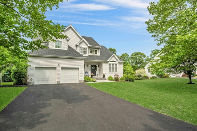 3 Vista Dr, Baldwin Place, NY 10505 - traditional-style house featuring asphalt driveway, a garage, a front lawn, and roof with shingles