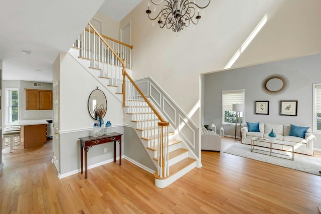 3 Vista Dr, Baldwin Place, NY 10505 - stairway featuring wood finished floors, plenty of natural light, a chandelier, and a towering ceiling