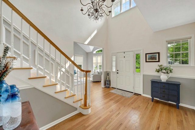 3 Vista Dr, Baldwin Place, NY 10505 - entryway featuring healthy amount of natural light, stairway, a towering ceiling, a chandelier, and wood finished floors