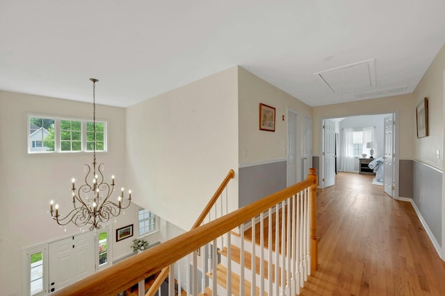 3 Vista Dr, Baldwin Place, NY 10505 - hall featuring attic access, light wood-type flooring, a chandelier, and an upstairs landing