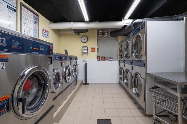 68-20 Selfridge St Unit 6J, Forest Hills, NY 11375 - community laundry room featuring stacked washer and clothes dryer, separate washer and dryer, and light tile patterned flooring