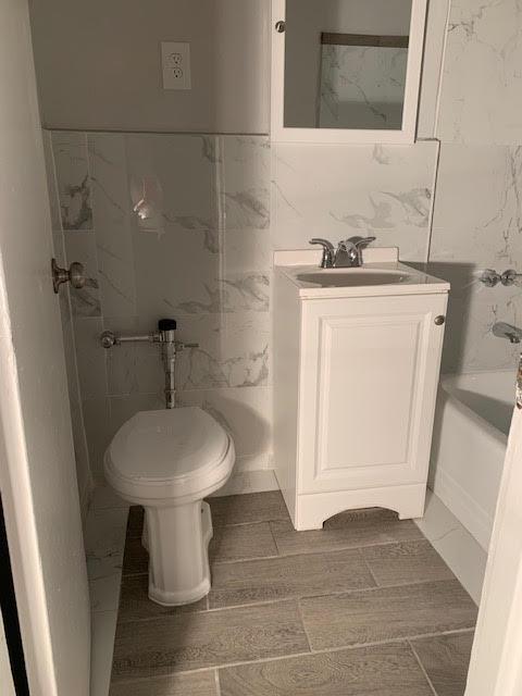 92-29 Lamont Ave Unit 2C, Elmhurst, NY 11373 - full bath featuring vanity and tile walls