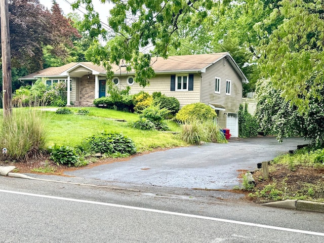 70 Nichols Rd, Nesconset, NY 11767 - view of front of property with driveway, an attached garage, stone siding, and a front lawn