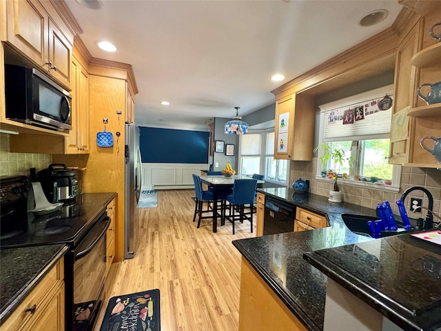 70 Nichols Rd, Nesconset, NY 11767 - kitchen with black appliances, a sink, open shelves, a wainscoted wall, and light wood-type flooring