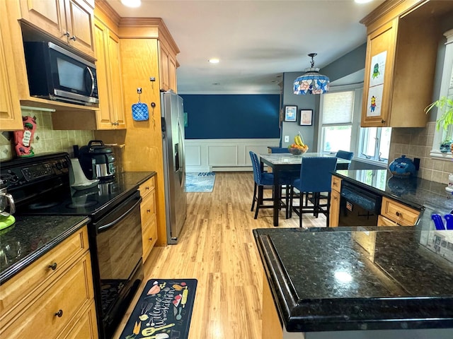 70 Nichols Rd, Nesconset, NY 11767 - kitchen with black appliances, a baseboard heating unit, a wainscoted wall, light wood finished floors, and backsplash