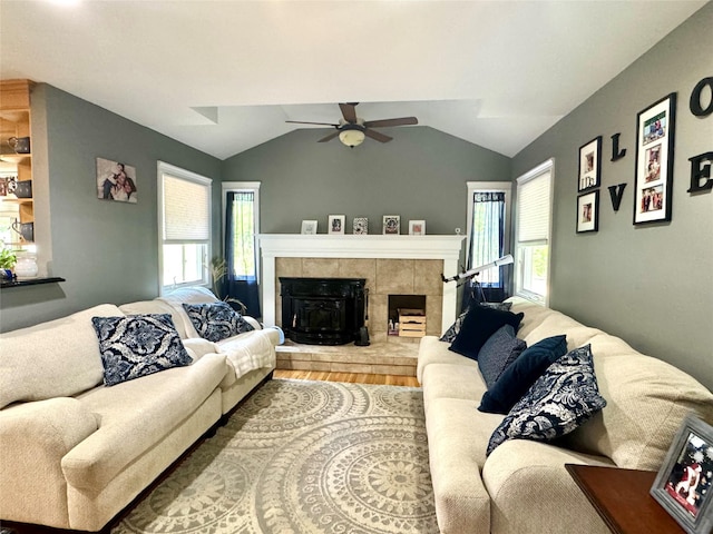 70 Nichols Rd, Nesconset, NY 11767 - living area featuring ceiling fan, vaulted ceiling, a fireplace, healthy amount of natural light, and wood finished floors