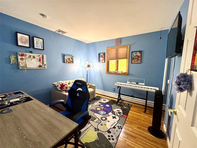70 Nichols Rd, Nesconset, NY 11767 - home office with wood finished floors and a baseboard heating unit