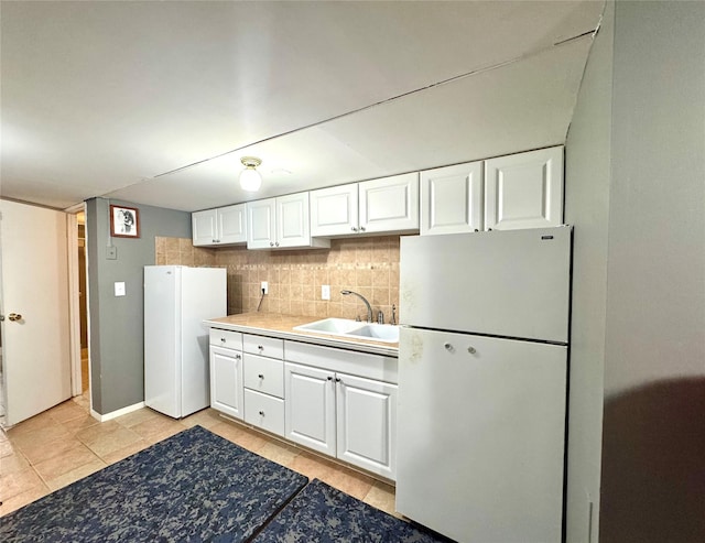 70 Nichols Rd, Nesconset, NY 11767 - kitchen featuring freestanding refrigerator, a sink, and white cabinetry