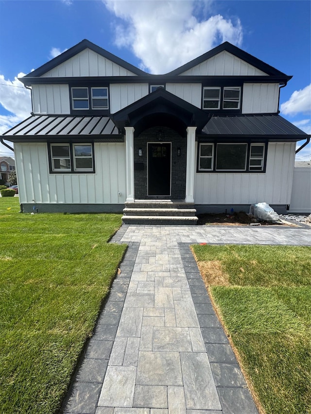 1541 Midian St, North Merrick, NY 11566 - view of front of house featuring a standing seam roof, metal roof, a front yard, and board and batten siding