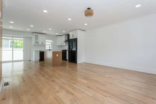 1541 Midian St, North Merrick, NY 11566 - unfurnished living room with recessed lighting, light wood-style floors, baseboards, and crown molding