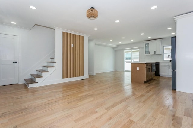 1541 Midian St, North Merrick, NY 11566 - unfurnished living room featuring recessed lighting, light wood-style floors, stairs, baseboards, and ornamental molding