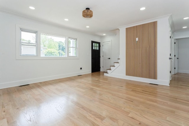 1541 Midian St, North Merrick, NY 11566 - unfurnished living room with crown molding, stairway, light wood-style floors, recessed lighting, and baseboards