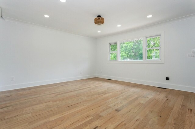 1541 Midian St, North Merrick, NY 11566 - spare room featuring light wood finished floors, baseboards, ornamental molding, and recessed lighting
