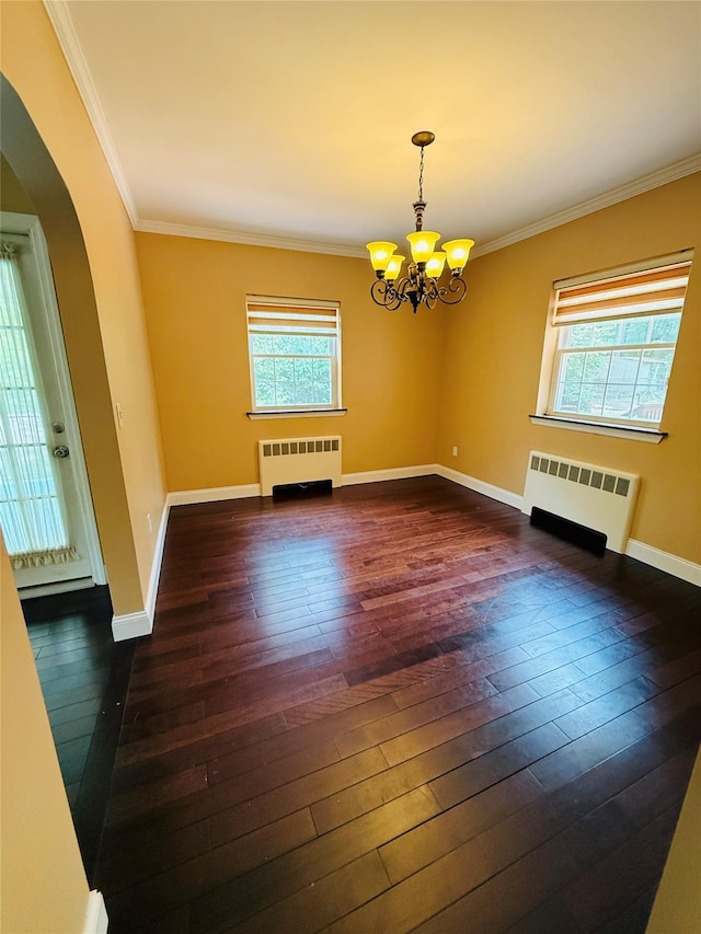 56 Elwood Rd, Northport, NY 11768 - unfurnished room featuring radiator heating unit, arched walkways, a chandelier, dark wood-style flooring, and ornamental molding