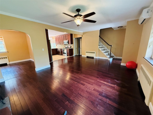 56 Elwood Rd, Northport, NY 11768 - living room with radiator heating unit, arched walkways, a ceiling fan, and crown molding