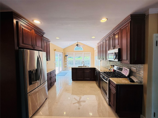 56 Elwood Rd, Northport, NY 11768 - kitchen featuring stainless steel appliances, a peninsula, vaulted ceiling, a sink, and tasteful backsplash