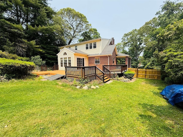 56 Elwood Rd, Northport, NY 11768 - rear view of house with a chimney, a deck, and brick siding