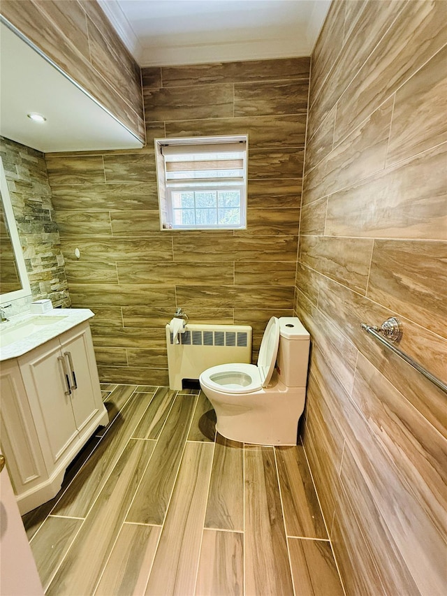 56 Elwood Rd, Northport, NY 11768 - half bath with radiator heating unit, toilet, and vanity