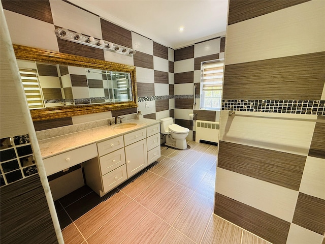 56 Elwood Rd, Northport, NY 11768 - full bath featuring radiator heating unit, tile walls, toilet, vanity, and tile patterned flooring