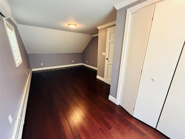56 Elwood Rd, Northport, NY 11768 - additional living space featuring dark wood-style floors, baseboards, and lofted ceiling