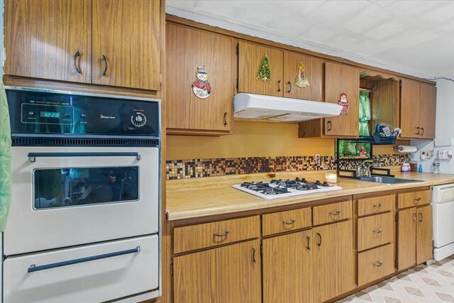 111-38 114th St, South Ozone Park, NY 11420 - kitchen with a warming drawer, white appliances, under cabinet range hood, a sink, and light countertops
