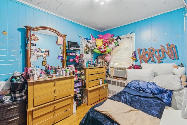 111-38 114th St, South Ozone Park, NY 11420 - bedroom featuring radiator, crown molding, wood finished floors, cooling unit, and wood walls