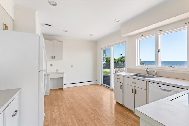 167 Secatogue Ln W, West Islip, NY 11795 - kitchen featuring white appliances, baseboard heating, a sink, light countertops, and light wood finished floors