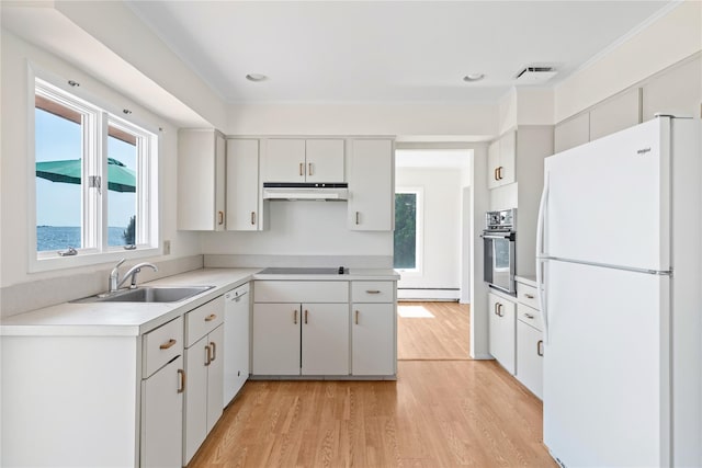 167 Secatogue Ln W, West Islip, NY 11795 - kitchen featuring black appliances, under cabinet range hood, a sink, plenty of natural light, and ornamental molding