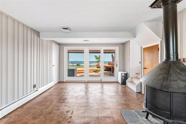 167 Secatogue Ln W, West Islip, NY 11795 - tiled living area featuring a wood stove and crown molding