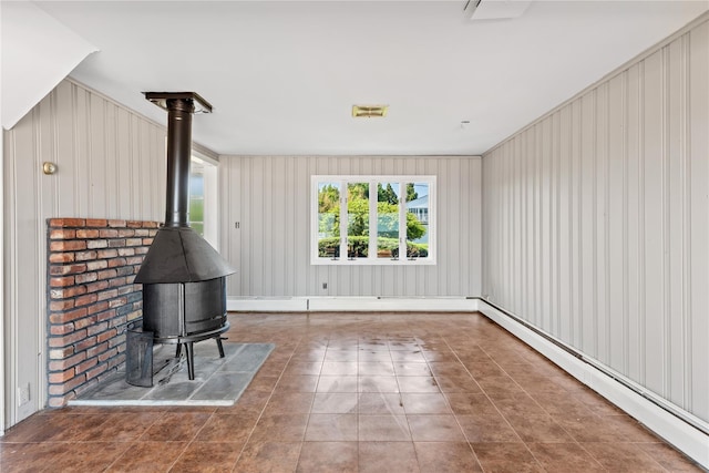 167 Secatogue Ln W, West Islip, NY 11795 - unfurnished living room with baseboard heating and a wood stove