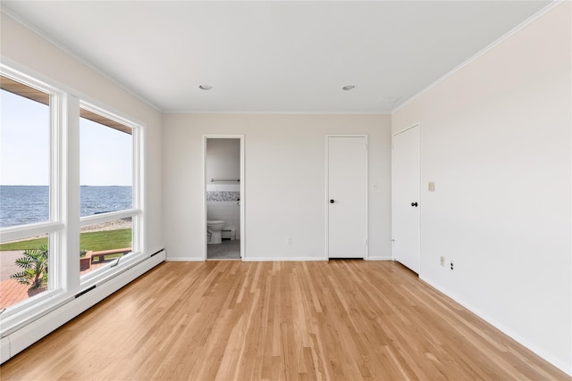 167 Secatogue Ln W, West Islip, NY 11795 - unfurnished bedroom featuring a baseboard heating unit, a water view, light wood-style flooring, baseboards, and crown molding
