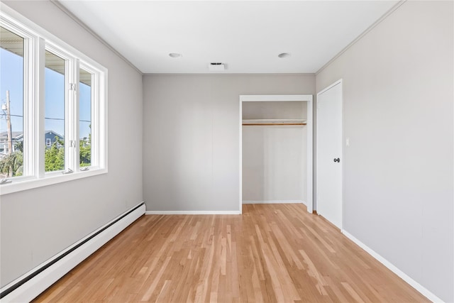 167 Secatogue Ln W, West Islip, NY 11795 - unfurnished bedroom with baseboard heating, light wood finished floors, a closet, and baseboards