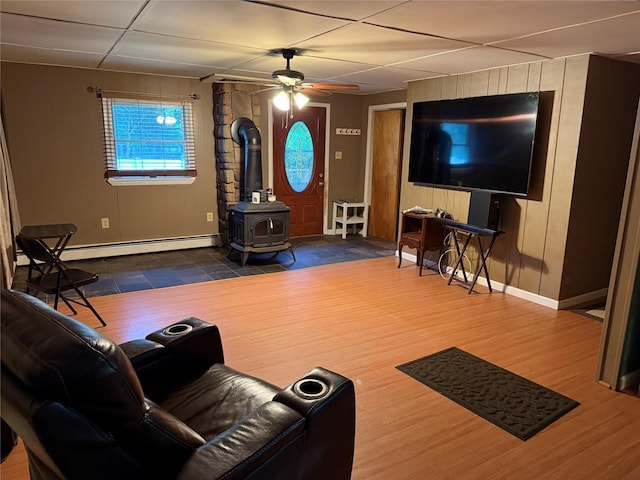 1546 Denning Rd, Claryville, NY 12725 - living area with a wood stove, a baseboard radiator, baseboards, and ceiling fan