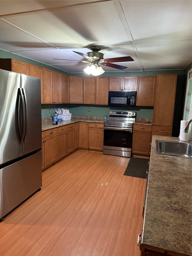 1546 Denning Rd, Claryville, NY 12725 - kitchen featuring stainless steel appliances, a sink, brown cabinetry, light wood-type flooring, and ceiling fan
