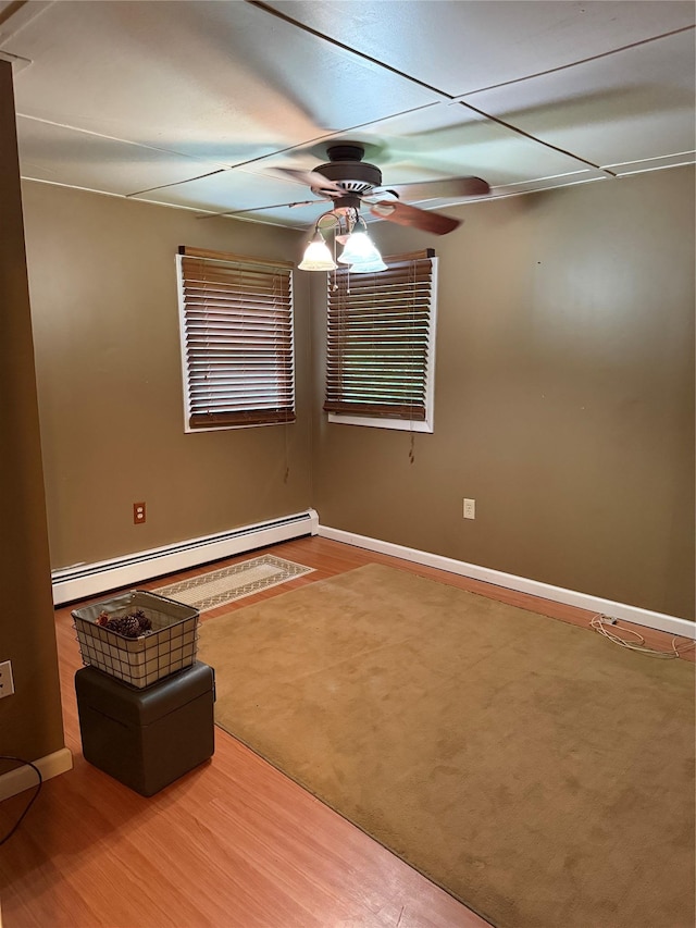 1546 Denning Rd, Claryville, NY 12725 - unfurnished room with a baseboard radiator, ceiling fan, baseboards, and wood finished floors