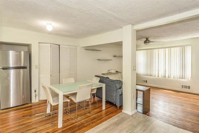 18 Hilliard Ave, Central Islip, NY 11722 - dining area with a textured ceiling, wood-type flooring, ceiling fan, and baseboards