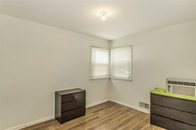 18 Hilliard Ave, Central Islip, NY 11722 - spare room with baseboards, wood finished floors, and a wall mounted AC