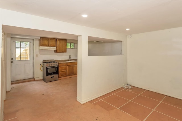 18 Hilliard Ave, Central Islip, NY 11722 - kitchen with stainless steel gas stove, a sink, brown cabinetry, recessed lighting, and under cabinet range hood
