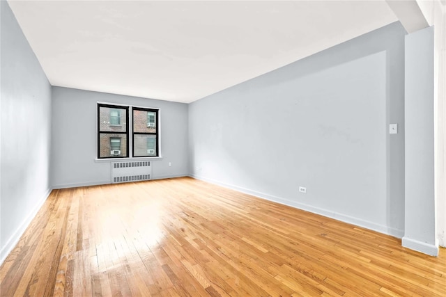 37-50 87th St Unit 4A, Jackson Heights, NY 11372 - unfurnished room with radiator heating unit, light wood-type flooring, and baseboards