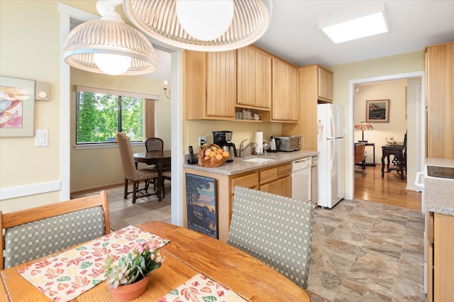 298 Heritage Hls Unit A, Somers, NY 10589 - kitchen with white appliances, light brown cabinetry, light countertops, a sink, and stone finish floors