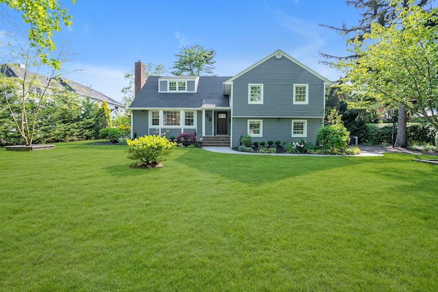 56 Washington Ave, Garden City, NY 11530 - view of front of home with a front lawn and a chimney