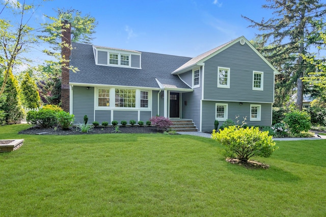 56 Washington Ave, Garden City, NY 11530 - split level home with a chimney, a front lawn, and a shingled roof