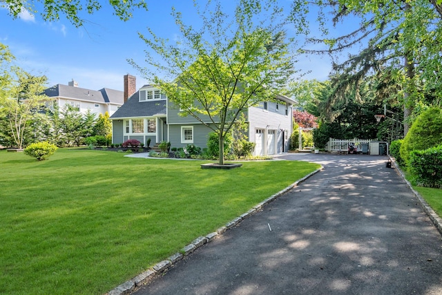 56 Washington Ave, Garden City, NY 11530 - view of front of property with a garage, asphalt driveway, and a chimney