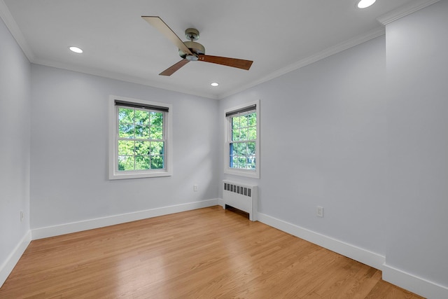 56 Washington Ave, Garden City, NY 11530 - spare room with radiator, healthy amount of natural light, crown molding, light wood-type flooring, and baseboards