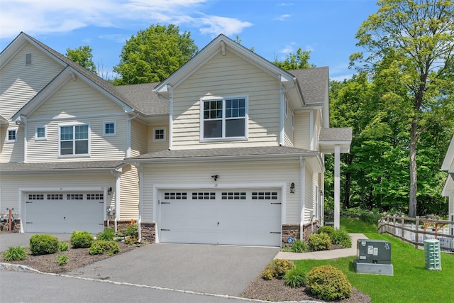 19 Woodrose Ct, Middletown, NY 10940 - view of front of property featuring an attached garage, stone siding, asphalt driveway, and a shingled roof