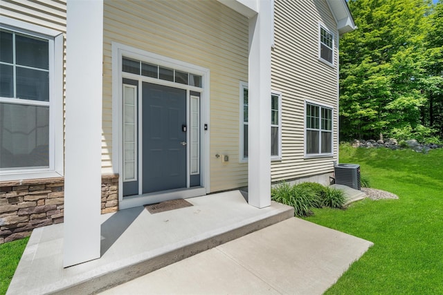 19 Woodrose Ct, Middletown, NY 10940 - doorway to property featuring cooling unit, a lawn, and stone siding