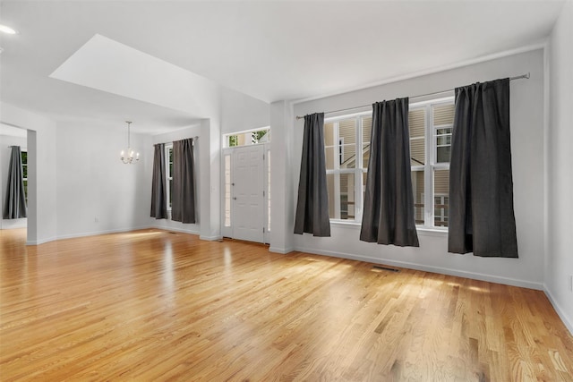 19 Woodrose Ct, Middletown, NY 10940 - unfurnished room with a chandelier, light wood-style flooring, and baseboards