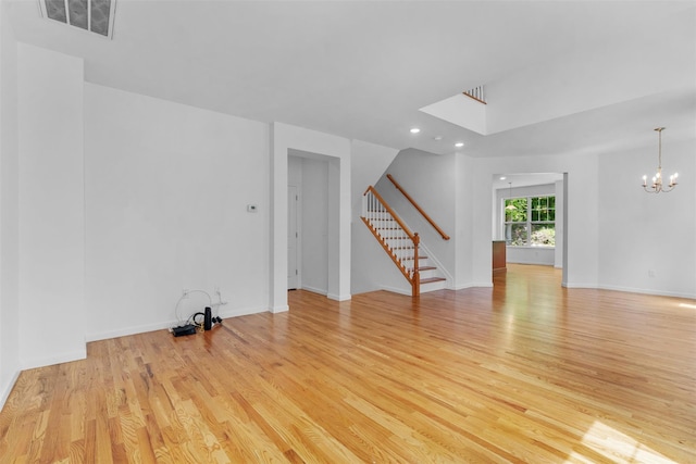 19 Woodrose Ct, Middletown, NY 10940 - spare room with stairway, light wood finished floors, a chandelier, recessed lighting, and baseboards